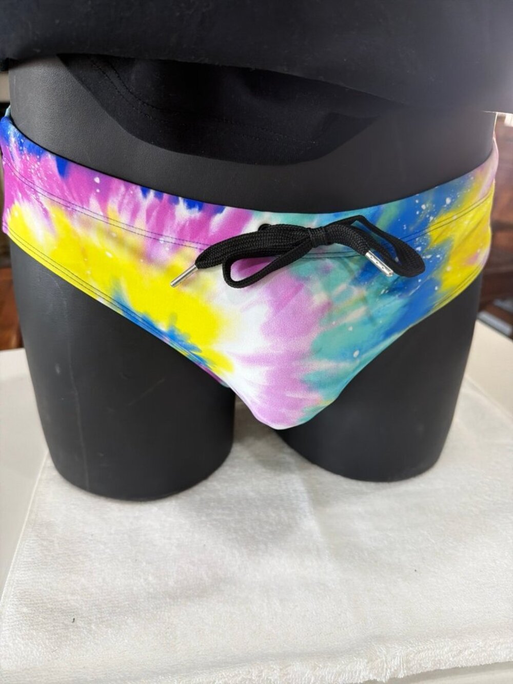 Pool Boy Sour Power swim briefs featuring a tie-dye print.